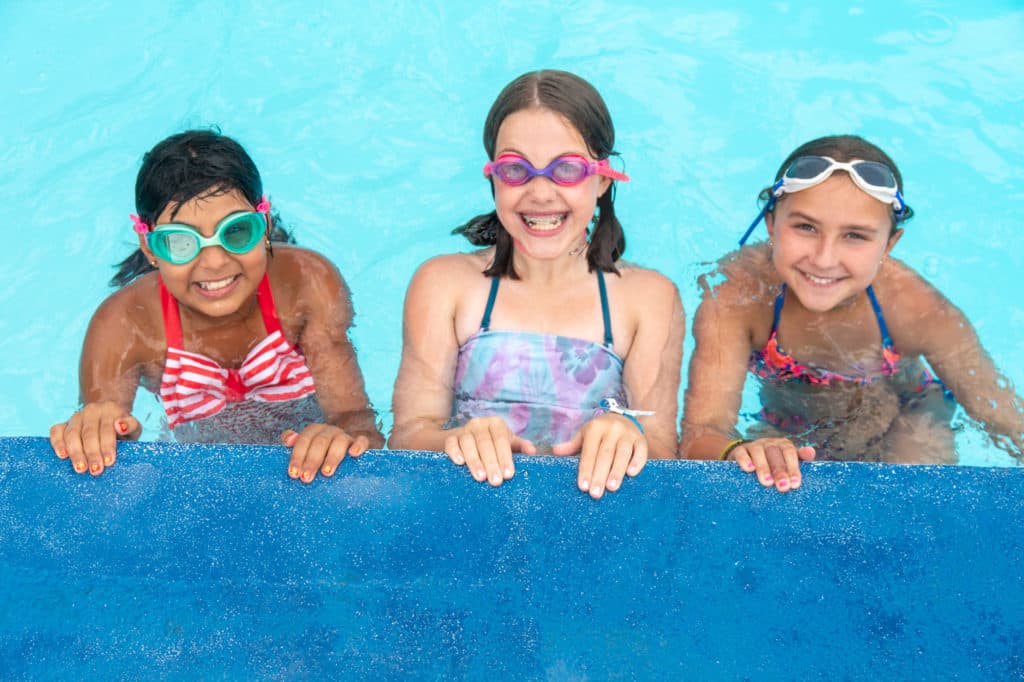 Campers swimming in one of the five heated pools at Camp Riverbend